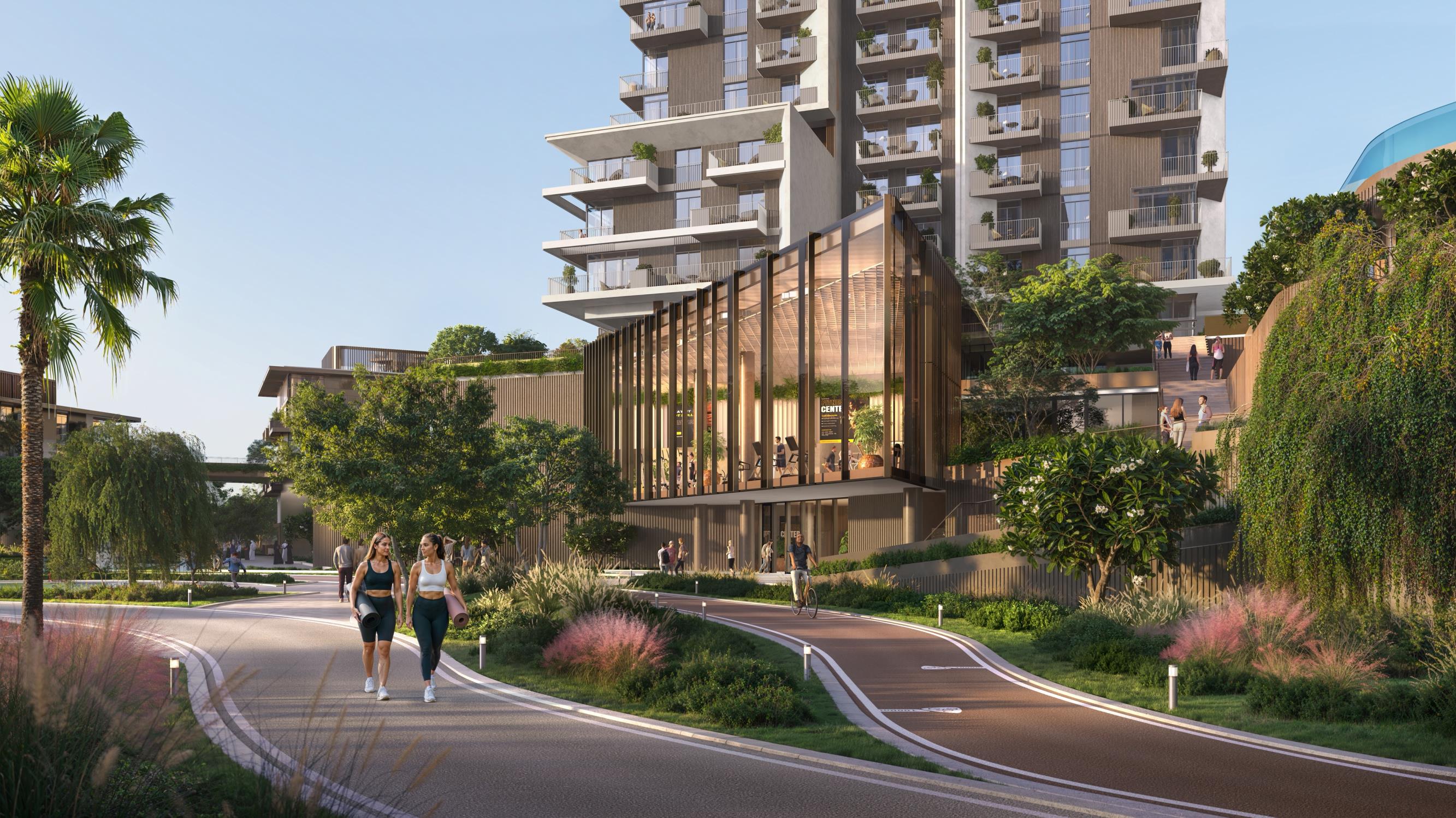 Rise by Athlon Dubai Land Dubai tower skyline view surrounded by lush greenery and community wellness amenities